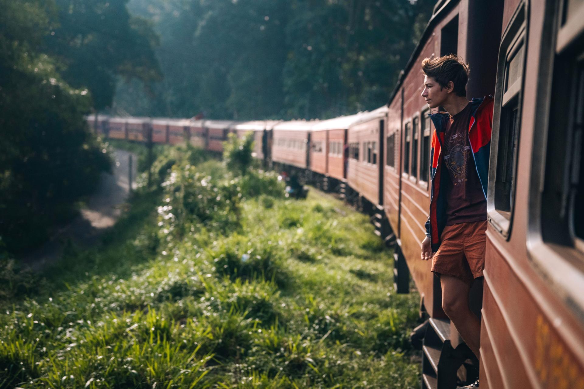 Man enjoys a train ride in Sri Lanka