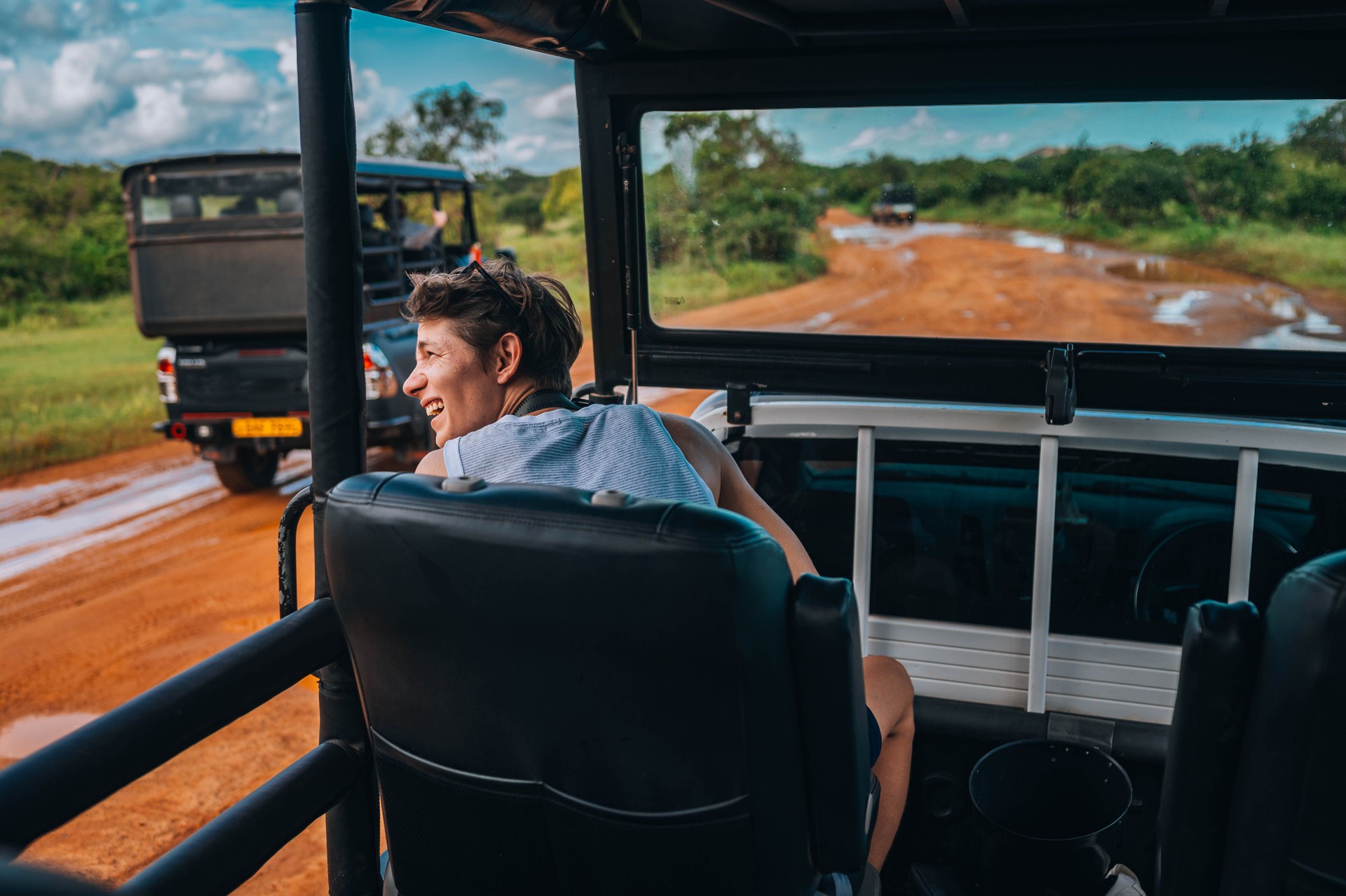 Young man on safari journey by off-road car in Sri Lanka.