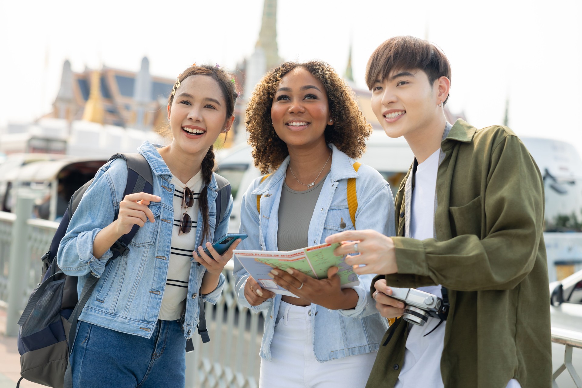 Group of  people tourist travel Temple in Thailand.Young tourist women exploring in the city of southeast Asia by using map for navigate to destination.